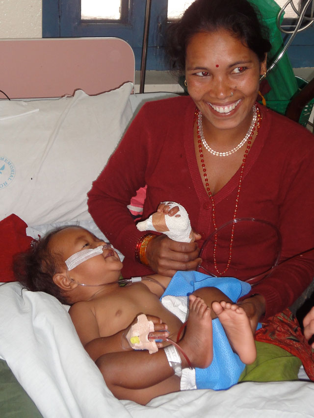 Nepalese mother happy after child has received surgery