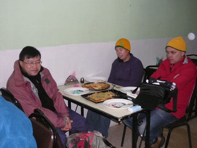 team enjoying a meal in the cold nepal