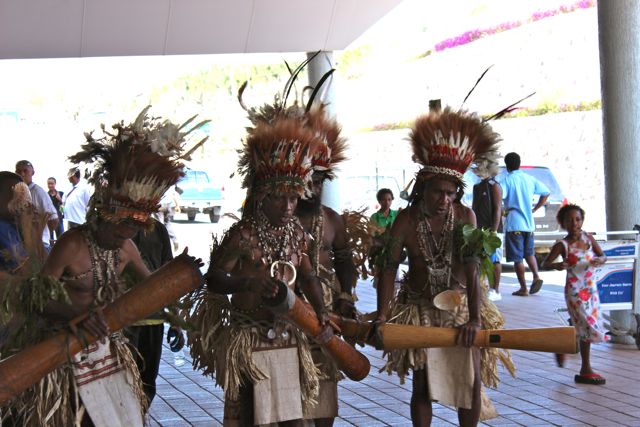 Team arriving in PNG with traditional dancers