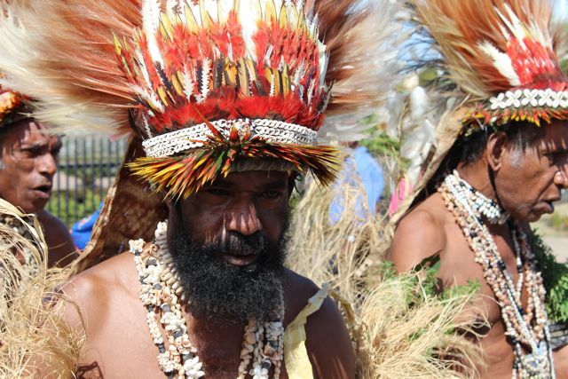 Team arriving in PNG with traditional dancers