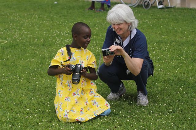 Volunteer and cardiac patient sharing time outside in Rwanda