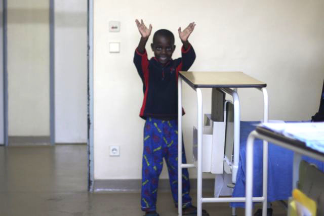 Rwandan cardiac patient waving goodbye